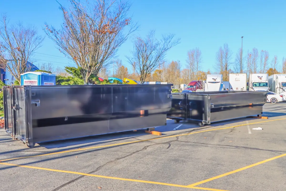 Professional dumpster rental service with roll-off container on residential driveway in North Codorus